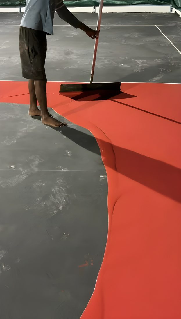Acrylic coating being applied by hand with a squeegee