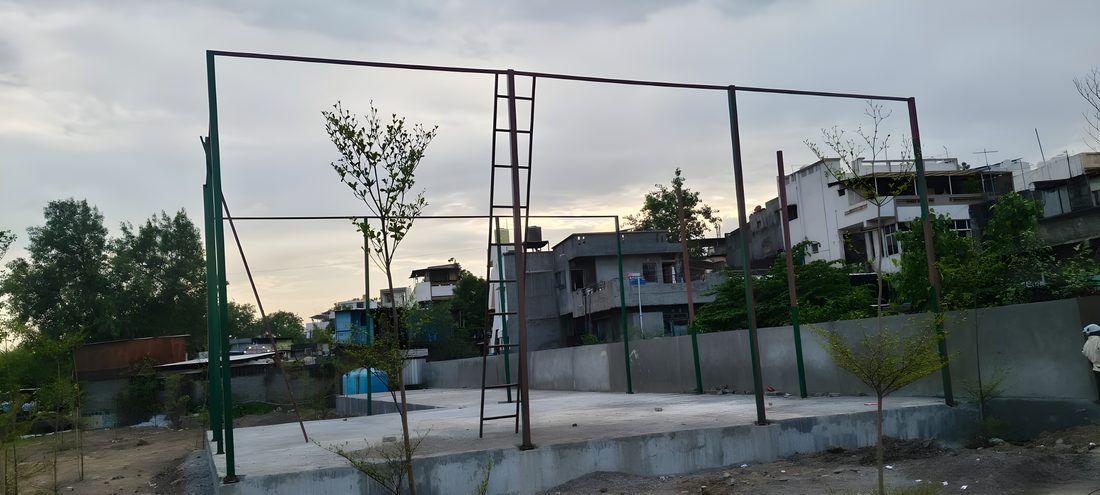 Court enclosure framework being erected on a finished base
