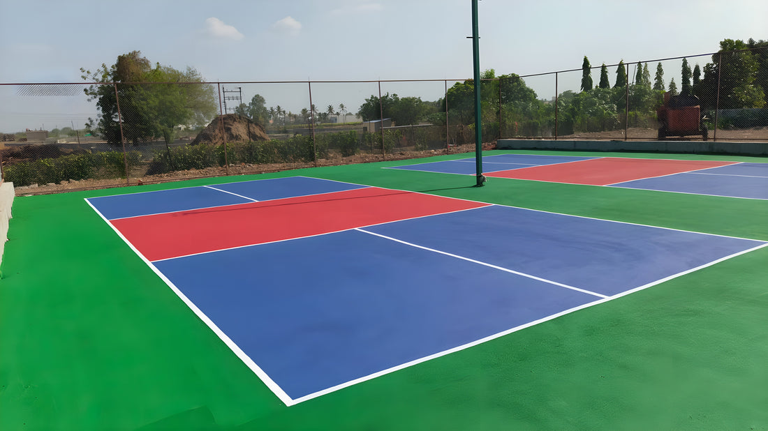 Finished acrylic sports court with blue and red zones — a ChampCourts installation
