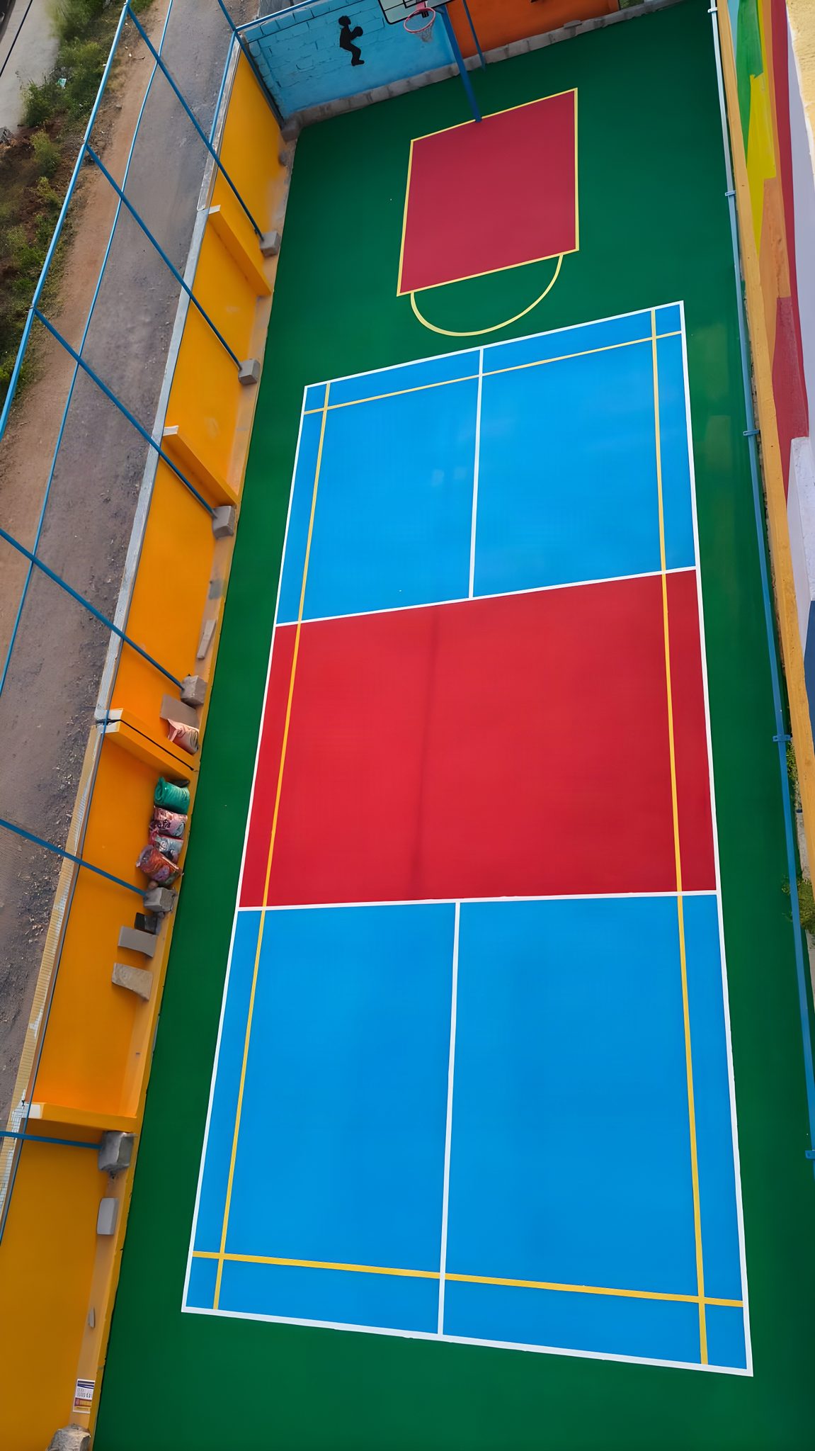 Aerial view of an acrylic multi-sport court with badminton and basketball markings at Sarda School, Hyderabad