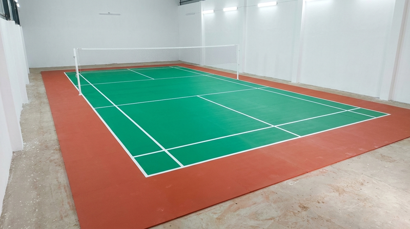 Freshly recoated badminton court after renovation, with crisp 40 mm BWF lines and even colour (visualization)