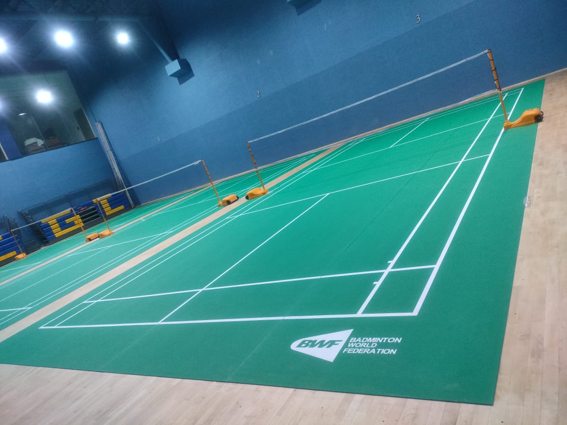 Multi-court indoor badminton stadium with BWF-grade PVC mat courts and wooden sprung surround