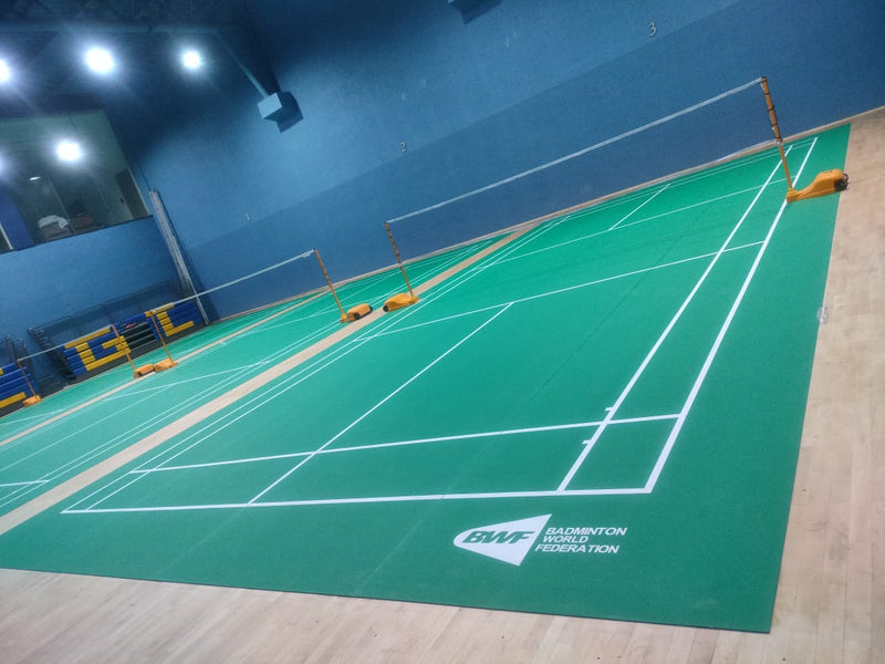 Multi-court indoor badminton stadium with BWF-grade PVC mat courts and wooden sprung surround