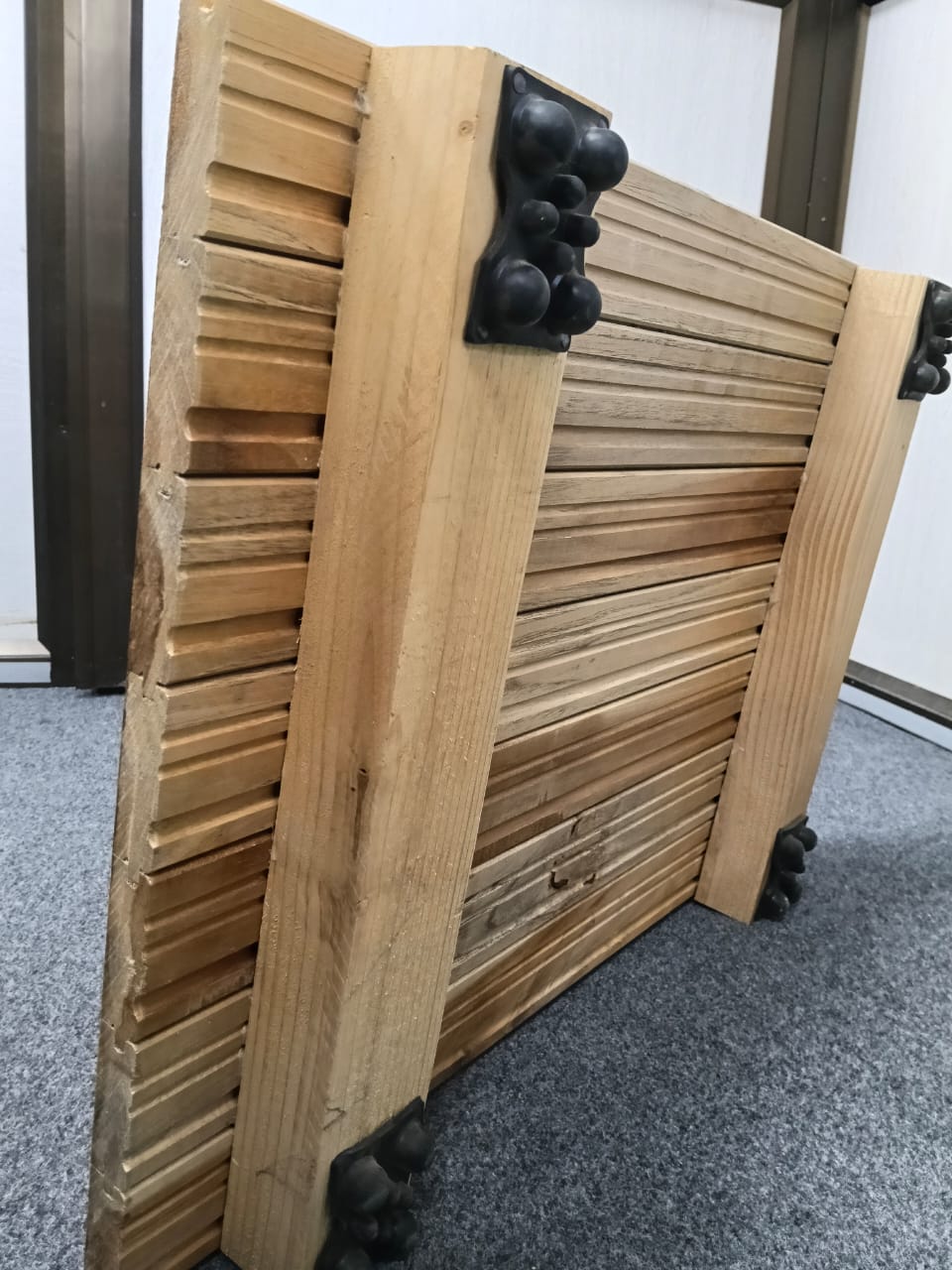 Underside of a teak air-cushion sprung floor panel showing battens and shock pads