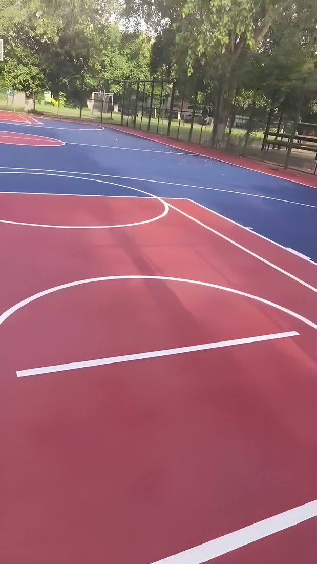Finished basketball court with key and boundary markings at a school
