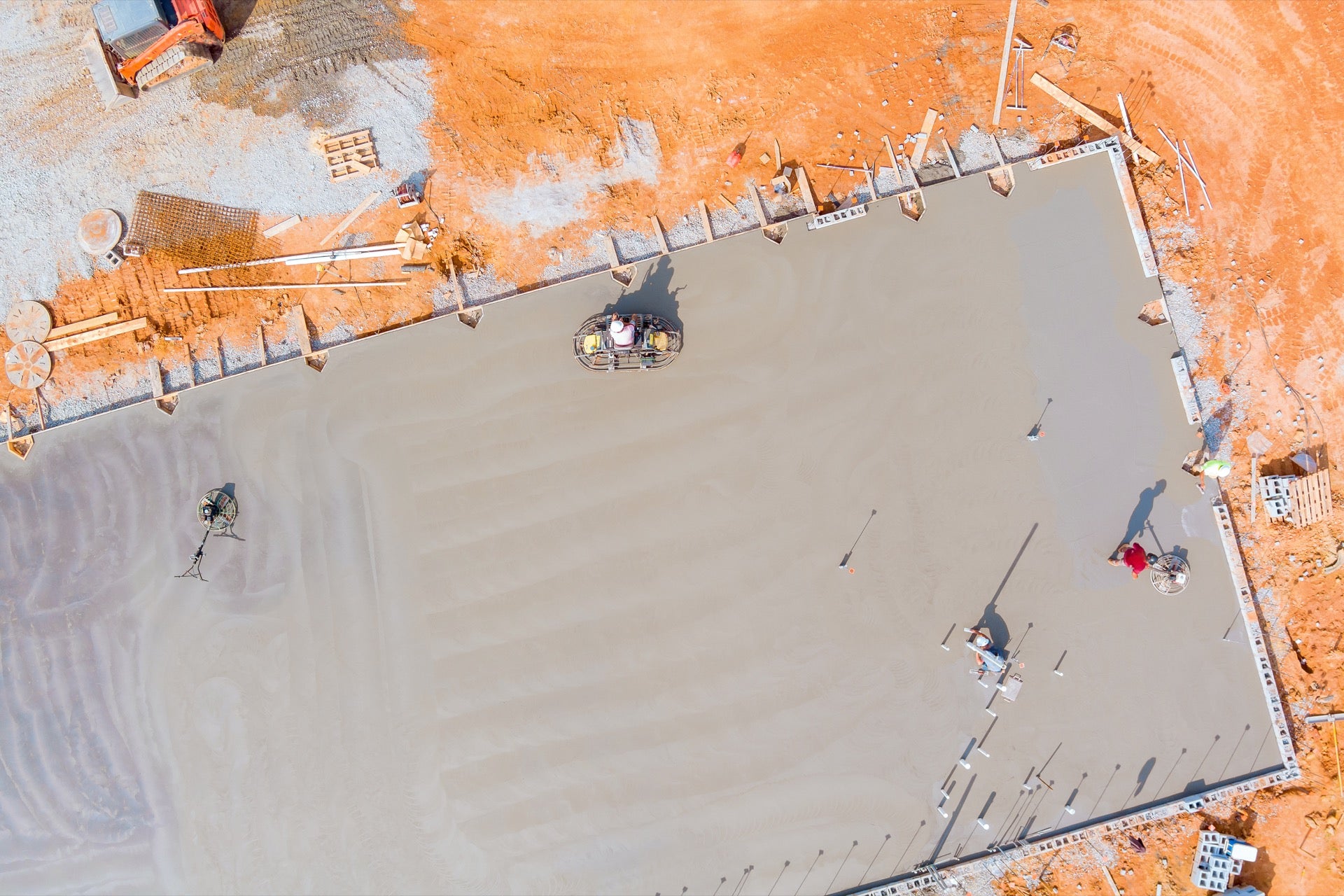 Acrylic-modified levelling compound being poured to correct the slope in the existing slab