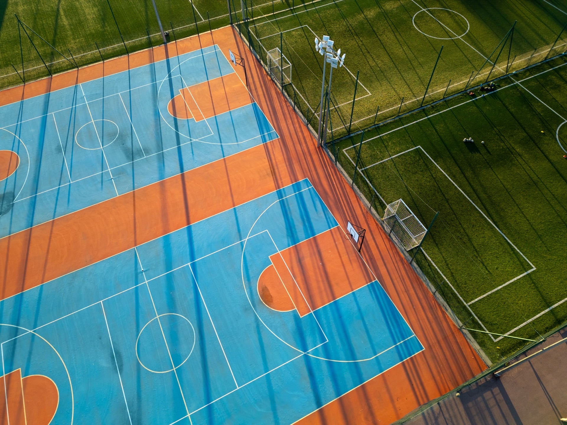 Royal Blue acrylic colour coat being applied on the basketball court