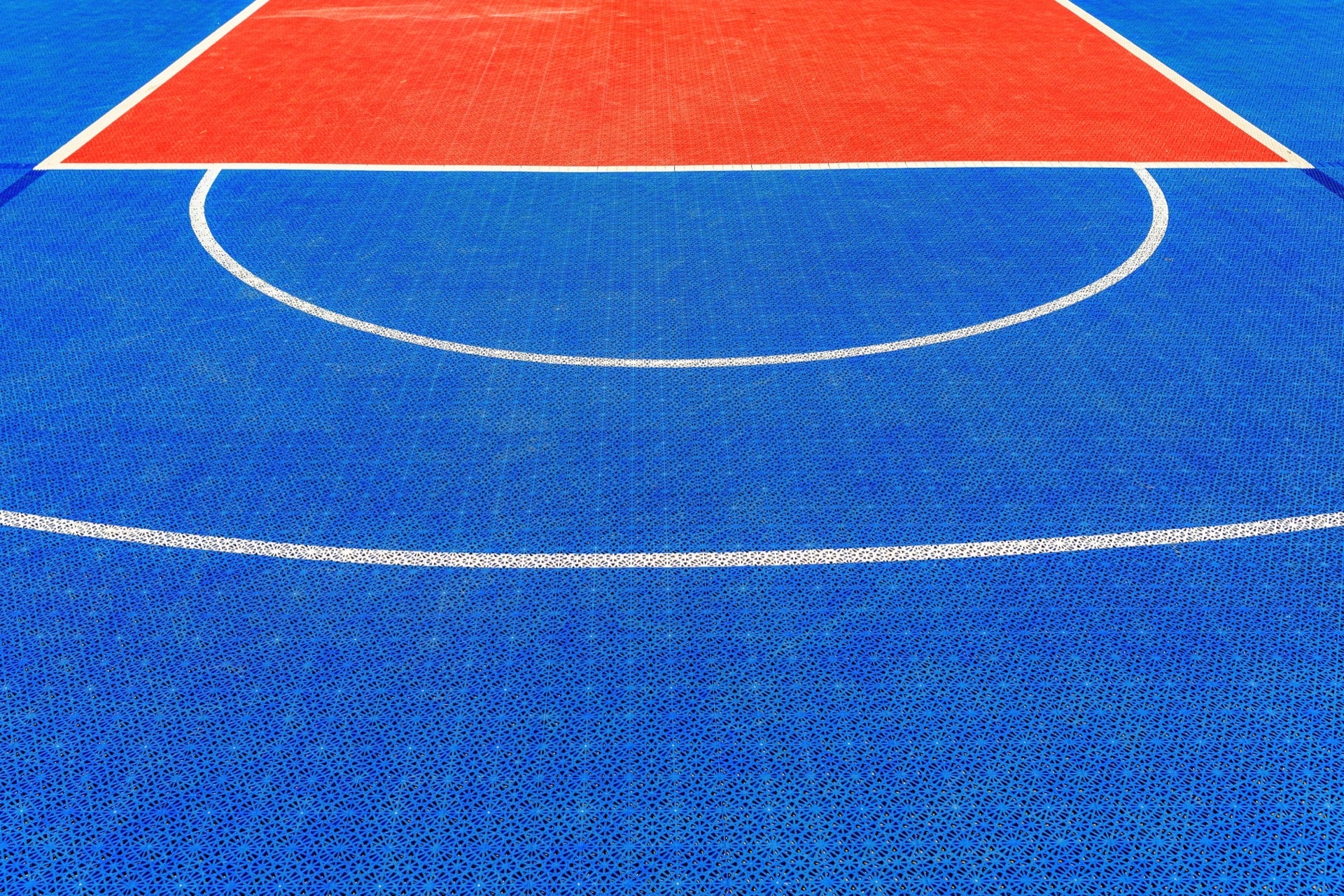 Green PP tile installation in progress between rain events